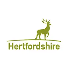 Green logo of Hertfordshire County Council featuring a silhouette of a stag standing on a hill above the word "Hertfordshire"
