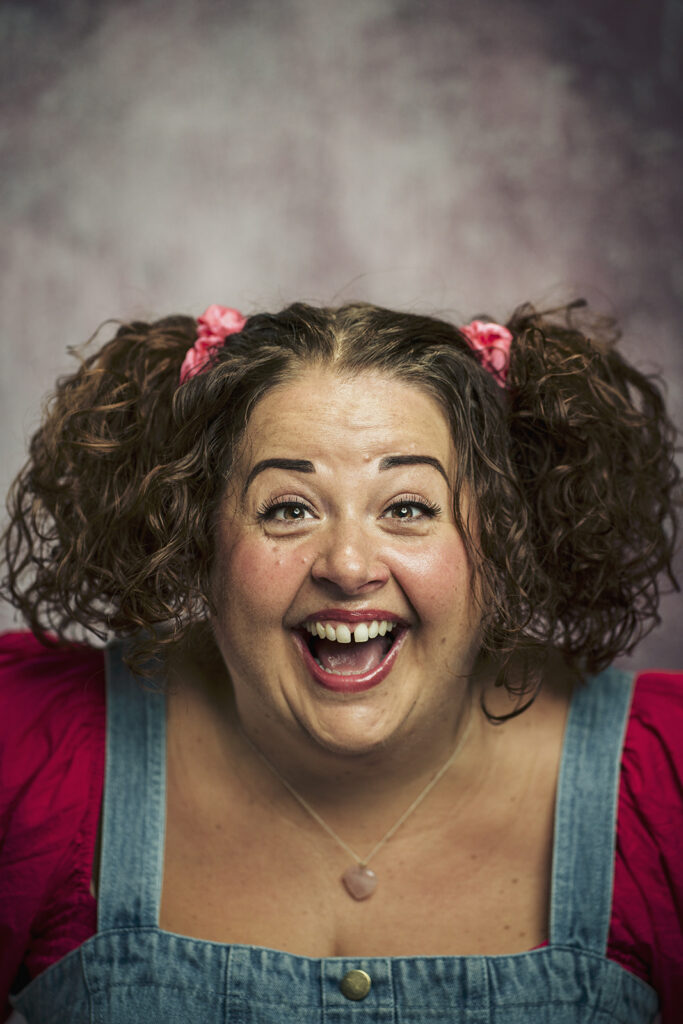 Expressive female actor smiling during a professional headshot session in St Albans, Hertfordshire.